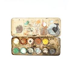 an old box filled with lots of paint