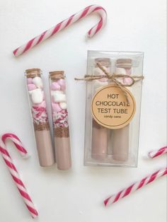 two pink and white candy canes sitting next to each other