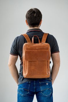 ● Large leather cognac backpack with big inside and outside pockets ● ● Large backpack is made by hand from genuine leather. Has three inner pockets and one large outer pocket with a flap. This backpack is suitable for both men and women. It can be used in everyday life for work, study, sports and travel. The backpack is made of high-quality genuine leather that guarantees its durable use.● ● Easily fits a 15.6 '' laptop in this backpack ● ● Unique leather over time gets better. A bag can be mad Leather Backpack With Luggage Sleeve, Cognac Leather Backpack, Functional Brown Backpack For Everyday Carry, Modern Brown Backpack For Everyday Carry, Everyday Carry Soft Leather Backpack, Soft Leather Everyday Backpack, Everyday Soft Leather Backpack, Cognac Backpack With Leather Backing For Travel, Brown Leather Backpack With Luggage Sleeve