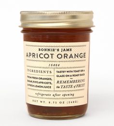 a jar of apricot orange marmalade on a white background