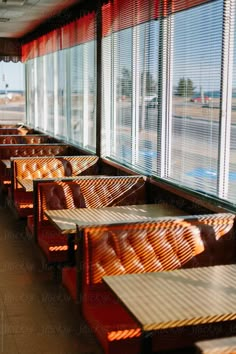 a row of benches sitting next to each other in front of a window filled with windows