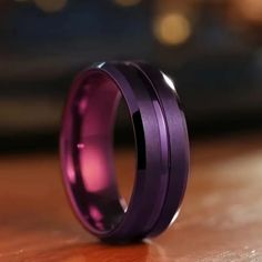 a purple ring sitting on top of a wooden table