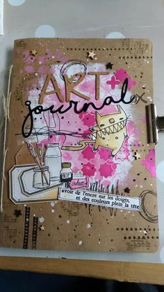 an art journal with pink flowers and writing on it