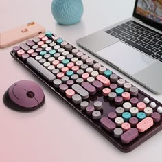 a laptop computer sitting on top of a desk next to a keyboard and mouse pad