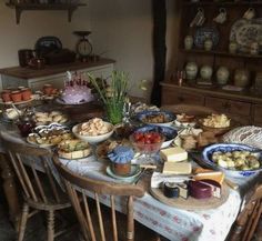 a table with many plates and bowls of food on it