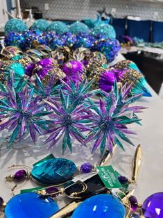 some blue and purple items are on a white table with other things in the background