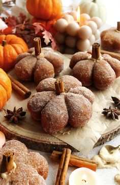 donuts and cinnamon sticks are arranged on a table