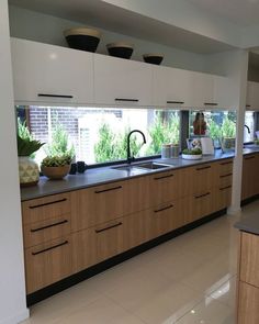 a kitchen filled with lots of counter top space next to a sink and stovetop oven