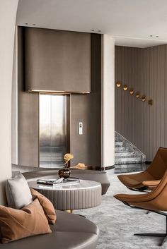 a living room filled with furniture next to a staircase