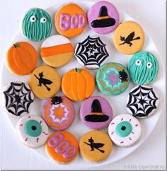 decorated halloween cookies arranged on a white plate