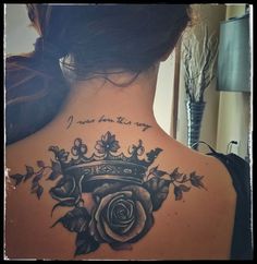 the back of a woman's neck with a rose and crown tattoo on it