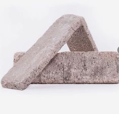 two cement blocks stacked on top of each other in the shape of a triangle and an arrow