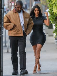 kim kardash and her husband are walking down the street in new york city