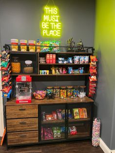 the inside of a grocery store with shelves and bins full of food, including snacks