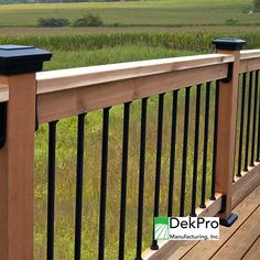 two mailboxes on the top of a wooden deck overlooking an open field and cornfield