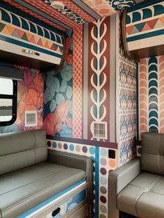 the interior of a train with colorful wallpaper