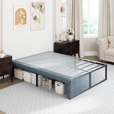 a bed frame that is in the middle of a living room with furniture and decor