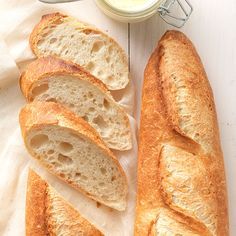 a loaf of bread sitting on top of a table next to a jar of butter