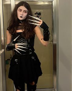 a woman dressed up as a monster holding a camera