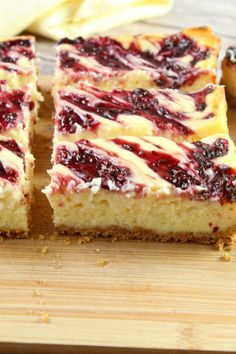 slices of cheesecake with berry toppings on a cutting board