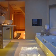 a bath room with a large tub and a sink