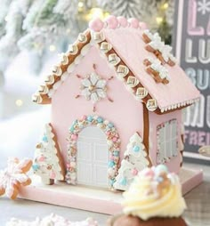 a pink gingerbread house on a table