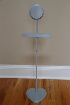 a metal pole with a circular object on it's top and two poles in the middle