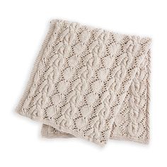 two white knitted napkins sitting on top of each other