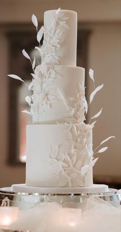 a wedding cake with white flowers on it