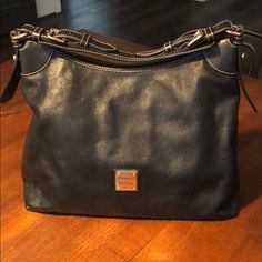 Dooney & Bourke Hobo Bag. Black All Weather Leather With Light Gold Tone Hardware. Slight Wear On The Bottom Corners But Great Shape Overall, See Photos. Comes With Dustbag. Leather Hobo Bag, Dooney & Bourke Bags, Leather Hobo, Dooney Bourke, Hobo Bag, Dust Bag, Black Leather, Bag Lady, Leather