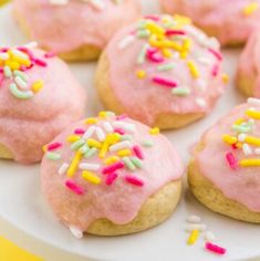 pink frosted donuts with sprinkles on a plate