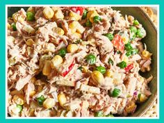 a green bowl filled with corn salad on top of a table