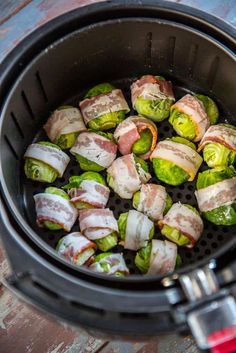 brussel sprouts in an air fryer with bacon wrapped around them