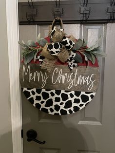 a door hanger with a merry christmas sign hanging on it's front door