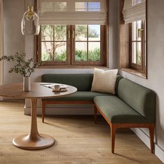 a living room with a couch, table and window sill on the wall next to it