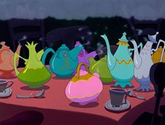 cartoon characters sitting at a table with teapots and cups on top of it