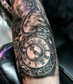 a man with a clock tattoo on his arm