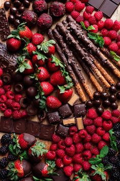 chocolates, strawberries, raspberries and more are arranged on a table