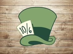 a green top hat with the number 10 on it, sitting against a wooden background