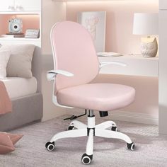 a pink office chair sitting in front of a bed