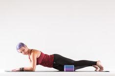 a woman is doing an exercise on her stomach