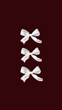 three white bows on a black background