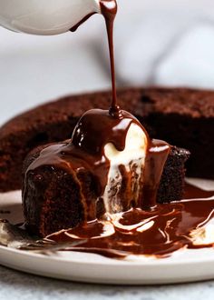 a piece of chocolate cake is being drizzled with caramel