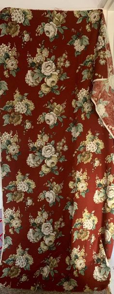 an old red floral fabric with white flowers on it