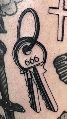 a close up of a tattoo with keys on it