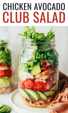 a mason jar filled with chicken avocado club salad