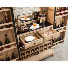 a wooden cabinet filled with lots of bottles and glasses on top of shelves next to each other