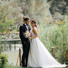 a bride and groom standing next to each other