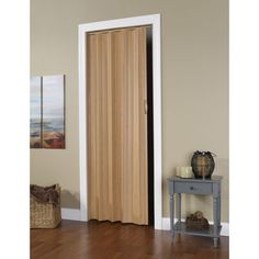 an open door in a room with wood flooring and white trim on the walls