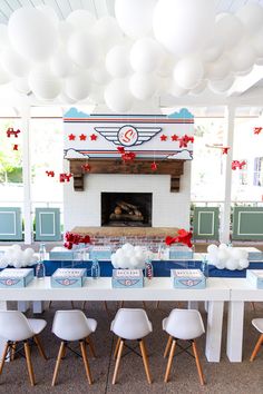 a long table is set up with white chairs and blue napkins for an american flag themed party